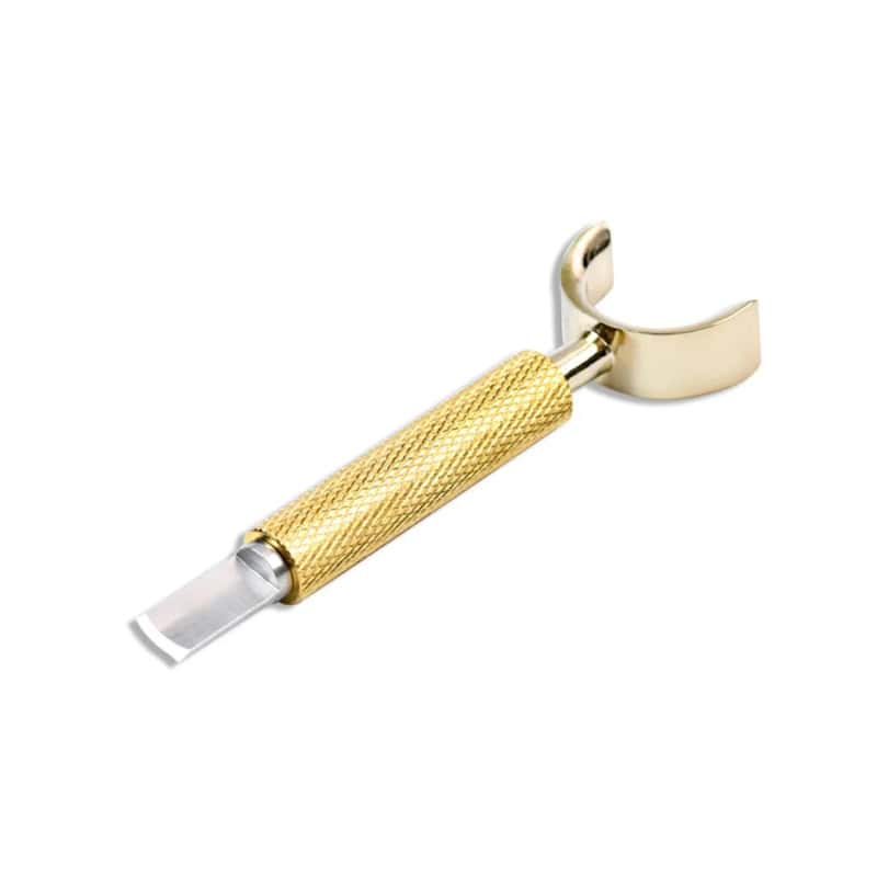 Gold safety razor with textured handle and curved head for men's grooming and shaving products.