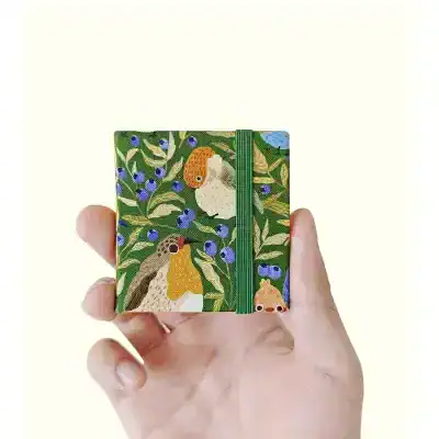 Colorful bird-themed notebook with elastic strap, ideal for fashion-forward accessories or gifts at Monalisa Store.