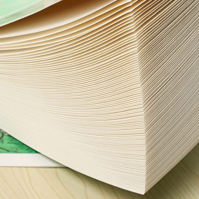 Stack of paper or cardboard sheets ready for printing or packaging, showcasing quality and precision, ideal for optometry or medical product labels at Monalisa Store.