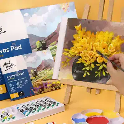 Vibrant yellow flower painting on canvas being created with paint tubes and brushes, perfect for art enthusiasts and painting lovers.