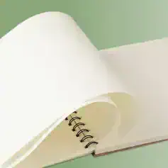 Clean white medical notebook with spiral binding on a green background.