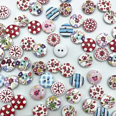 Assorted colorful fabric-covered buttons with floral and polka dot patterns, perfect for clothing and craft sewing projects.