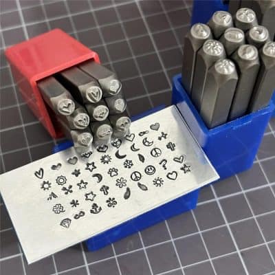 Stamped metal nail art stamps with various designs for creative manicure patterns.