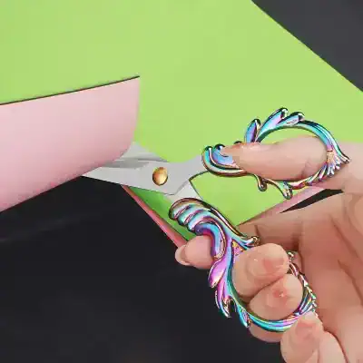 Colorful metal keychain with an iridescent finish, shaped like decorative leaves and swirls, on a vibrant background. Perfect for accessories or gifting, showcasing Monalisa Store's trendy jewelry collection.