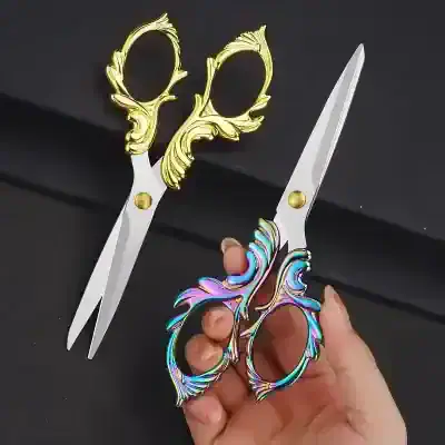 Gold and rainbow-colored ornate scissors with intricate handle designs for beauty and personal care, perfect for hair styling or cosmetic use, showcased on a black background.