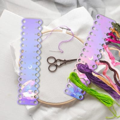 Colorful embroidery thread organizer board with sewing scissors and fabric, used for crafting, embroidery, and sewing projects. Perfect for needlework enthusiasts and DIY embroidery lovers.
