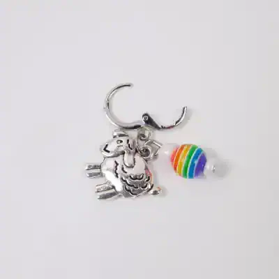 Colorful rainbow charm accessory featuring a unicorn with a rainbow-beaded tail, ideal for children's jewelry or fun accessories for kids.