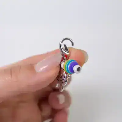 Colorful bead charm keychain for stylish accessories and jewelry, featuring rainbow-colored beads on a silver ring, perfect for personalizing bags, keys, or as a cute gift.