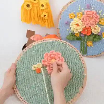 Flower embroidery art, handmade floral craft, creative needlework, textured fabric flower embroidery, floral wall decor DIY.