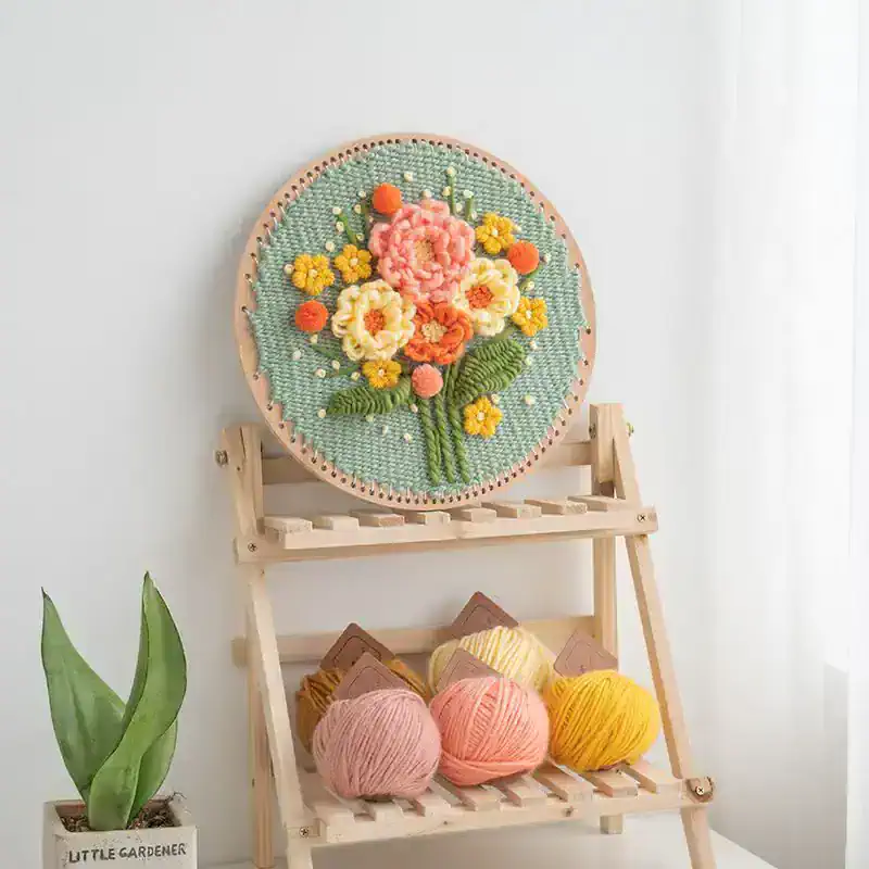 Colorful embroidered floral embroidery hoop art displayed on a wooden stand, ideal for home decor and craft enthusiasts. High-quality textile art piece perfect for adding a touch of elegance to any room.