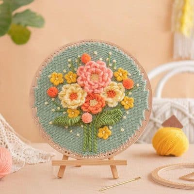 Colorful embroidered floral design on a round textile artwork, vibrant and detailed flower arrangement for home decor and embroidery art enthusiasts.