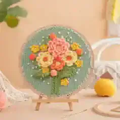 Pink and yellow floral embroidery on a circular textile art piece displaying intricate needlework, perfect for home decor, wall art, and craft enthusiasts from Monalisa Store.