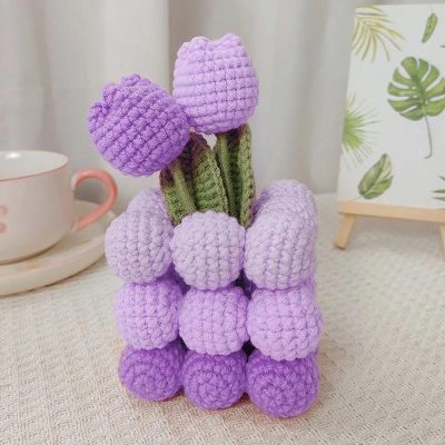 Bright purple and lavender knitted tulip flowers in a crochet vase, perfect for home decor or as a gift, available at Monalisa Store for unique, handmade craft enthusiasts and floral decor lovers.