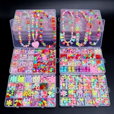 Colorful plastic bead necklaces and various craft accessories organized in transparent storage boxes at Monalisa Store.
