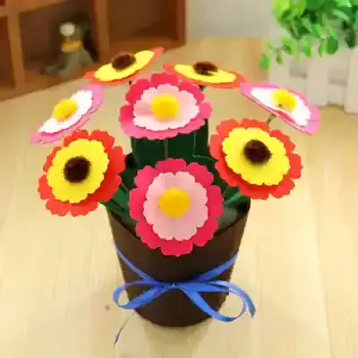 Vibrant paper flower bouquet in a black pot with blue ribbon, perfect for home decor or gift; handcrafted floral arrangement for opt Monalisa Store.