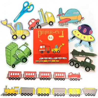 Colorful paper cut-out toy vehicles including trucks, trains, cars, planes, and a UFO, displayed with a red paper-themed craft book, ideal for children's educational and imaginative play activities.