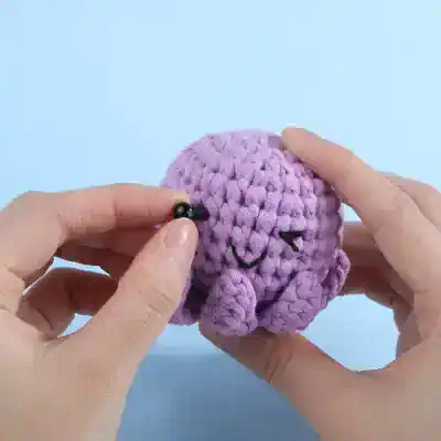 Soft purple crochet octopus plush, handmade amigurumi toy with black safety eyes and embroidered smile, perfect for kids, infants, and as a cute gift, Monalisa Store.