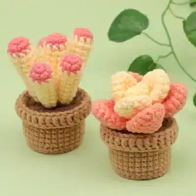 Colorful crochet cactus plants in brown pots – handmade decorative home accents for plant lovers and gardening enthusiasts.