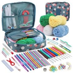 Colorful knitting and crochet starter kit with yarn, tools, and accessories in floral-printed case for DIY craft projects.