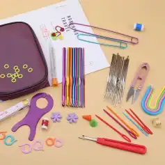 Colorful crochet hooks, scissors, stitch markers, and sewing accessories arranged on a light beige surface, showcasing premium quality crafting tools at Monalisa Store, ideal for knitting and crochet projects.