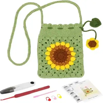 Colorful sunflower crochet bag with a yellow, brown, and green flower design, accompanied by a crochet hook, scissors, and instructional pattern sheet, perfect for handmade accessories or craft projects.
