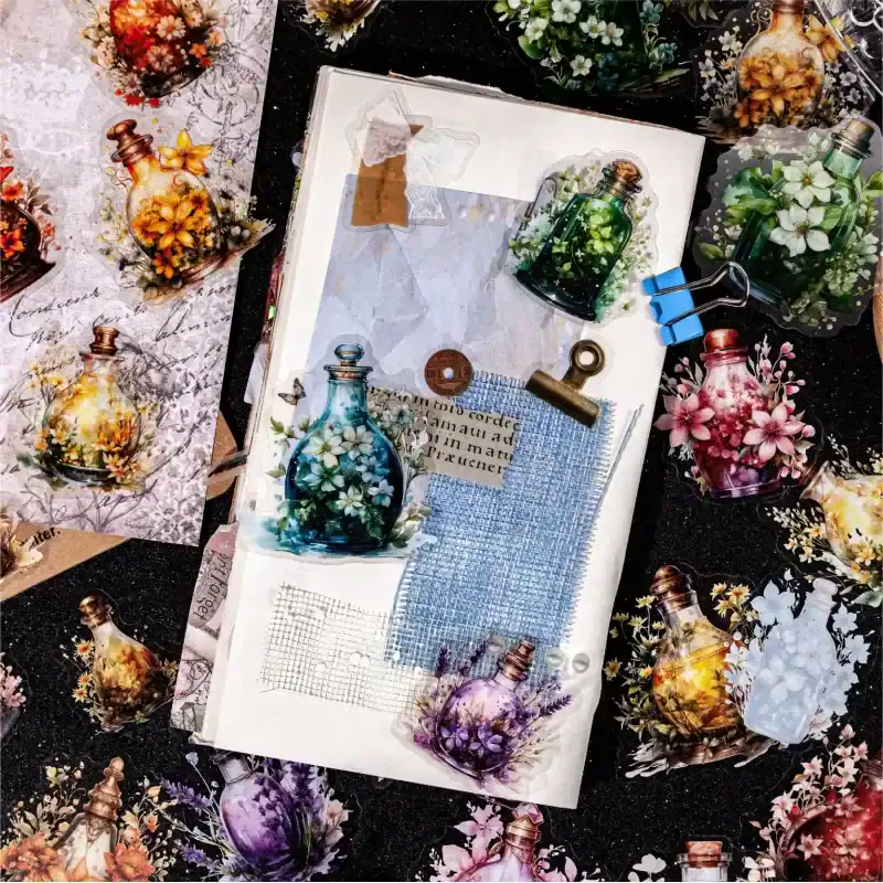 Beautiful floral-embellished glass perfume bottles and craft supplies arranged on a creative workspace at Monalisa Store, featuring decorative flowers and artistic materials for DIY projects and home decor, SEO optimized for gift and decor ideas.