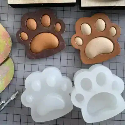 Paw-shaped molds and soaps, perfect for creating playful and animal-themed soap designs for pet lovers and pet salons, with a focus on unique soap crafting.