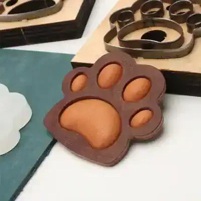 Cute paw-shaped chocolate soap mold for pet-themed skincare products, perfect for handmade soap enthusiasts and pet lovers. Unique design ideal for personalized pet gift soaps.