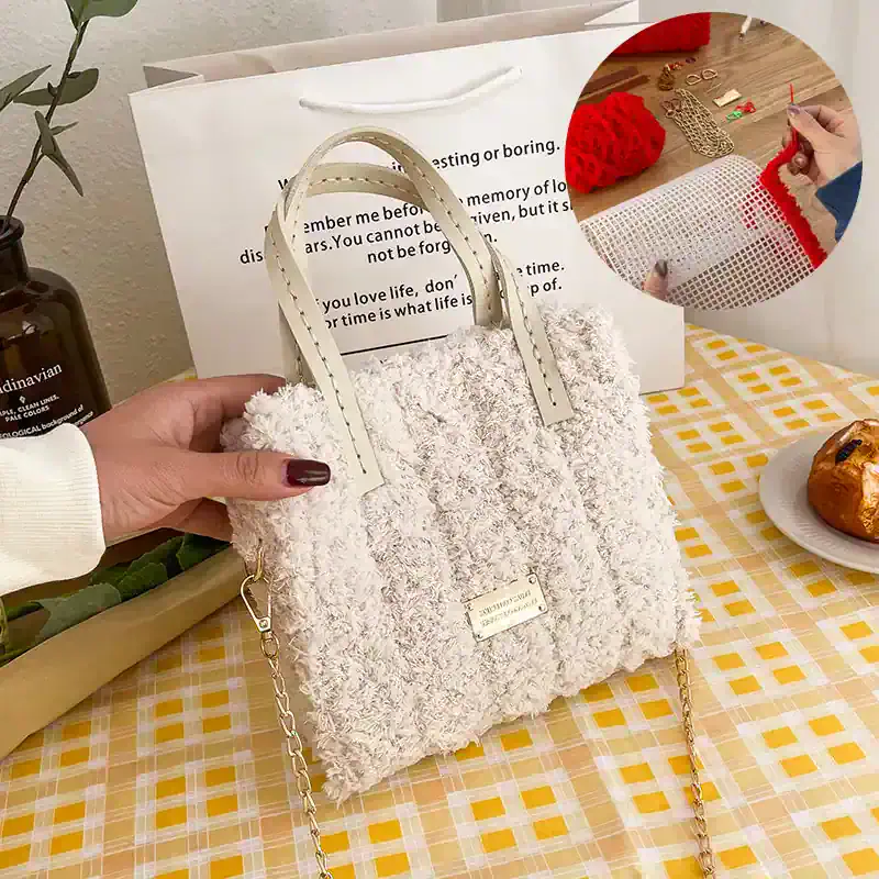 Soft white fluffy handbag with chain strap on a yellow checkered table, nearby a plate with bread, a plant, and shopping bag, showcasing trendy accessories at Monalisa Store for fashion and style enthusiasts.