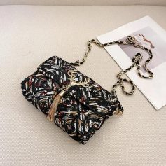 Elegant patterned designer handbag with gold chain strap for stylish accessories.