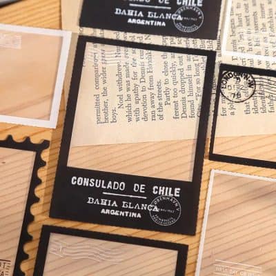 Passport-style photo frame with vintage stamps, Chile consulate, and travel-themed embellishments for collectible display.
