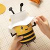Cute bee-themed storage container with a white hat lid, perfect for organizing small items. Fun and functional design, ideal for kids' rooms or playful office decor.