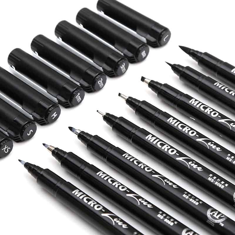 Fine tip black markers and pens for eyeglass lens engraving.