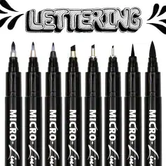 Markers for lettering and calligraphy, black ink pens, fine tip art markers, brush pens, and lettering tools arranged in a row against a white background at Monalisa Store.