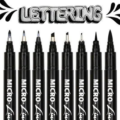 Markers for lettering and calligraphy, black ink pens, fine tip art markers, brush pens, and lettering tools arranged in a row against a white background at Monalisa Store.