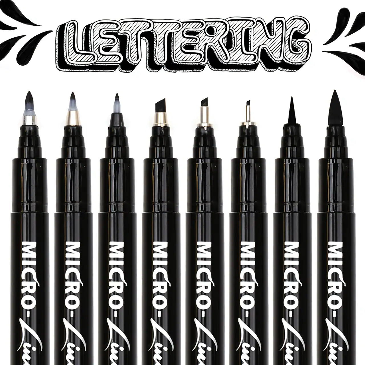 Markers for lettering and calligraphy, black ink pens, fine tip art markers, brush pens, and lettering tools arranged in a row against a white background at Monalisa Store.