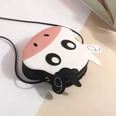 Cute cow-shaped purse for kids, featuring playful design and vibrant colors. Perfect for children’s accessories, combining fun with utility, ideal for gifting or everyday use.