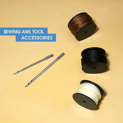 Colorful sewing awl tool accessories with spools of thread in brown, black, and white, and two sewing needles on a light yellow background perfect for textile and craft sewing projects.