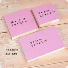 Colorful sticky notes with size measurements and product details on a wooden surface, perfect for office or school use.