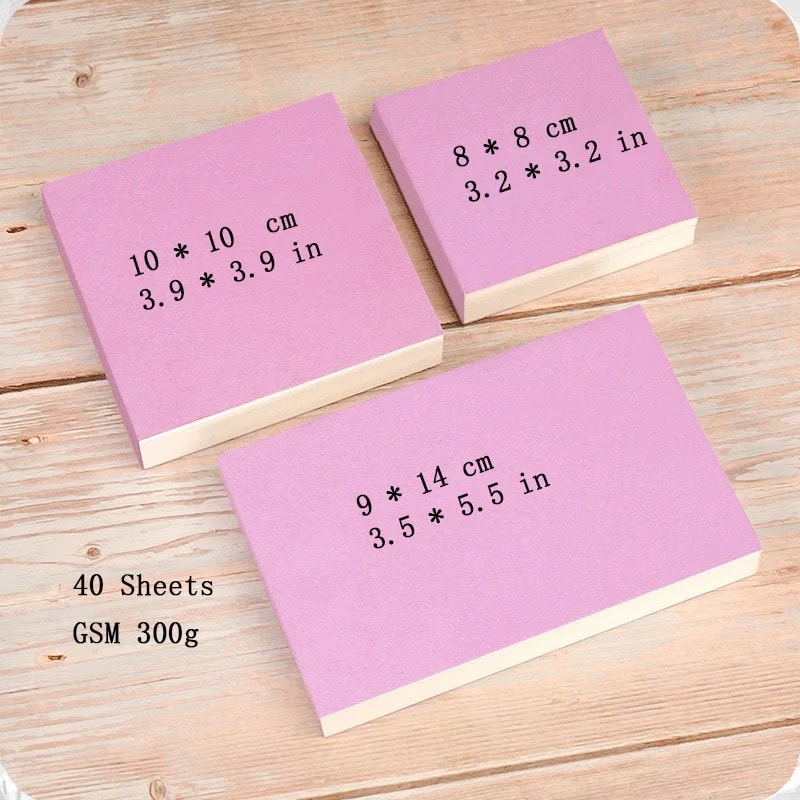 Colorful sticky notes with size measurements and product details on a wooden surface, perfect for office or school use.