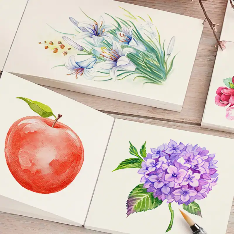Vibrant watercolor floral and fruit art collection featuring lilies, an apple, and hydrangeas, perfect for home decor or gift ideas.