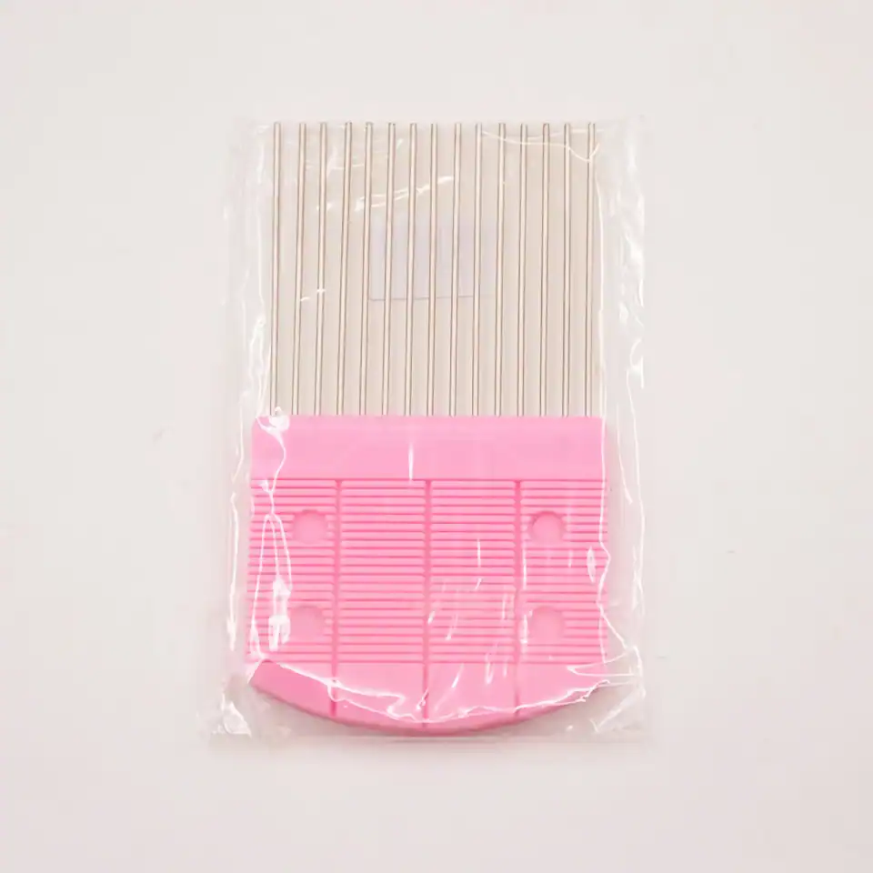 Disposable eyelash extension fan cleaning tool, pink plastic eyelash cleaning brush and comb for salon use.