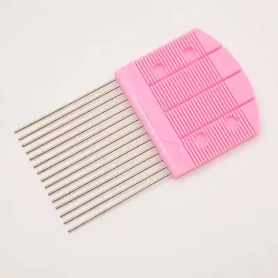 Precision eyelash extension tool with stainless steel pins and pink plastic handle for professional beauty treatments.