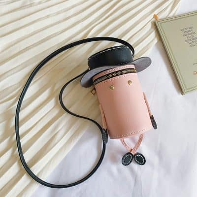 Miniature golf bag-shaped handbag, stylish designer accessory with black, pink, and grey accents, perfect for fashion-forward women seeking unique, trendy handbags for everyday or special occasions.