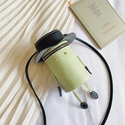 Miniature handbag with robot-like legs, leather material, black and green color, stylish accessory for women.