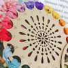 Multicolored embroidery floss on wooden thread organizer for sewing and crafting projects.