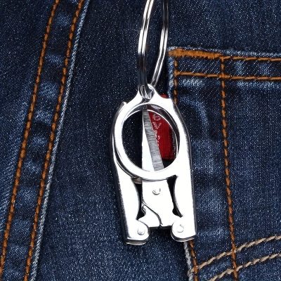 Metal keychain clip attached to denim pocket, fashion accessory for trendy street style, high-quality stainless steel, stylish and durable key holder, perfect for everyday use and personal organization.