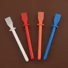Disposable eyelash extension applicator tools in white, red, pink, and blue for precise eyelash extension application.