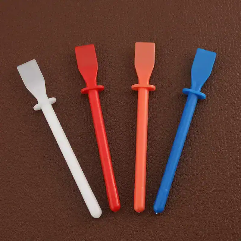 Disposable eyelash extension applicator tools in white, red, pink, and blue for precise eyelash extension application.