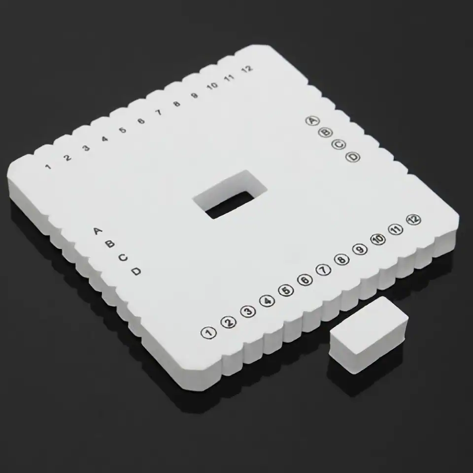 White Dominoes with letter and number markings for medical or educational games, displayed on black background.